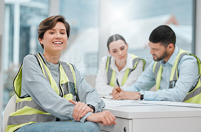 Buy stock photo Cropped portrait of an attractive young female construction worker sitting in a meeting with her colleagues