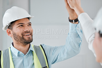Buy stock photo Cropped shot of a handsome young male construction worker highfiivng a female colleague on a building site