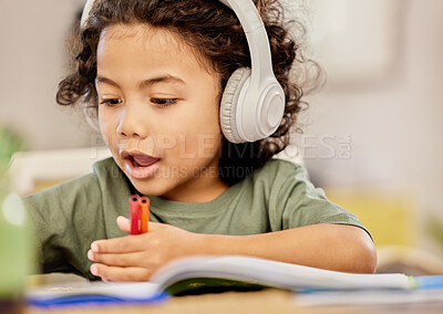 Buy stock photo Headphones, kid and homework with book on table for learning, knowledge or listening to music. Kindergarten, education and boy with tech at home for child development, homeschool and audio in project