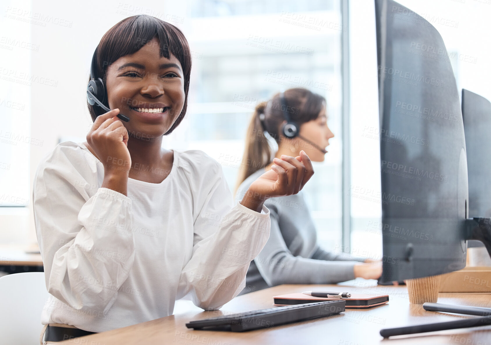 Buy stock photo Call center, smile and black woman with headset, talking and customer service in office and hand. CRM, telemarketing and person with tech support, speaking and agent on desk in agency and working