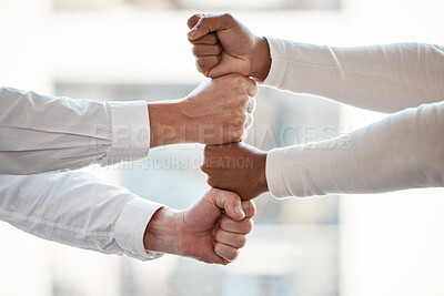 Buy stock photo Cropped shot of two unrecognizable businessmen stacking their fisted hands in the office
