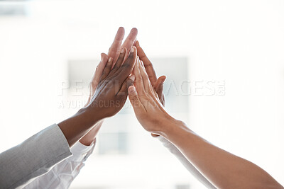 Buy stock photo Cropped shot of a group of unrecognizable businesspeople highfiving while standing in their office