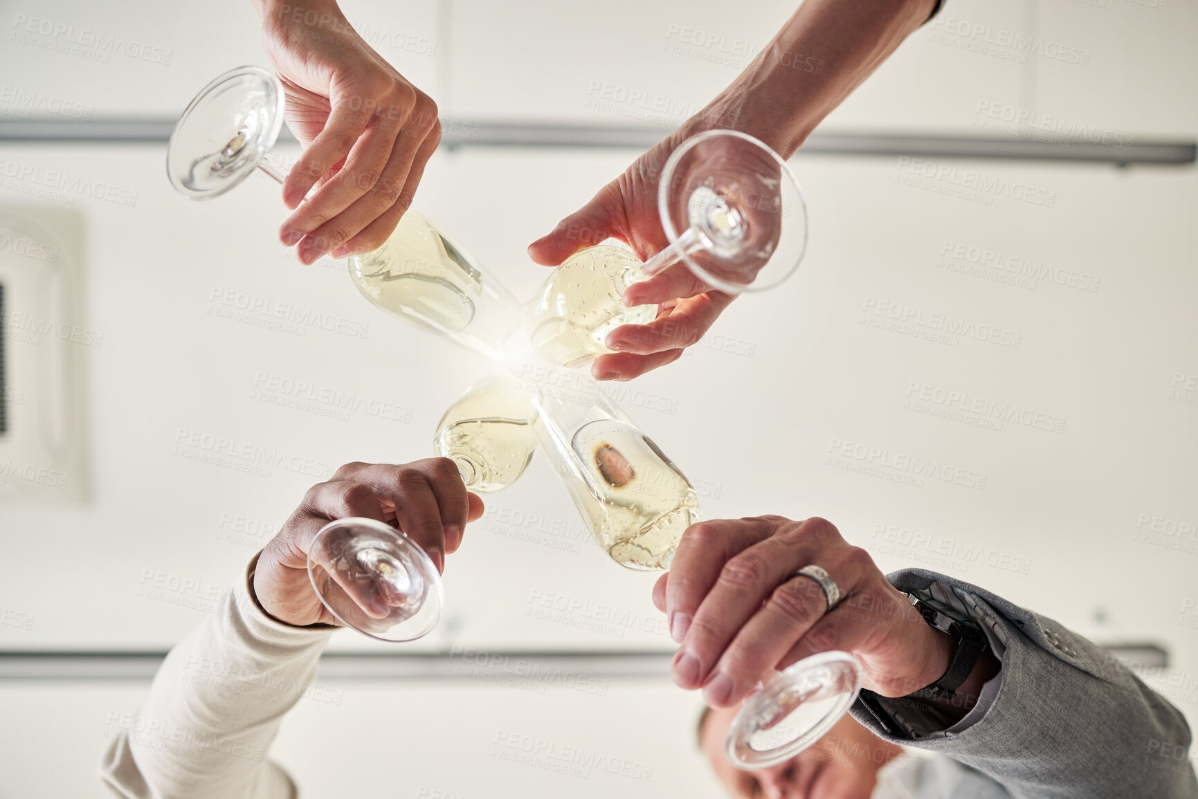 Buy stock photo Hands, champagne and party with toast at office in low angle, achievement or winning in circle at event. Men, people and glasses for drinks, goal or team building with celebration, success and scrum