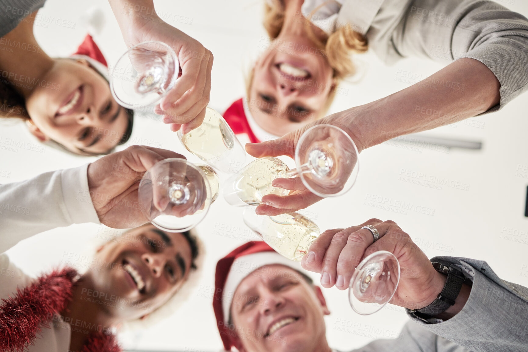 Buy stock photo Below shot of a group of business colleagues having a celebratory drink in an office