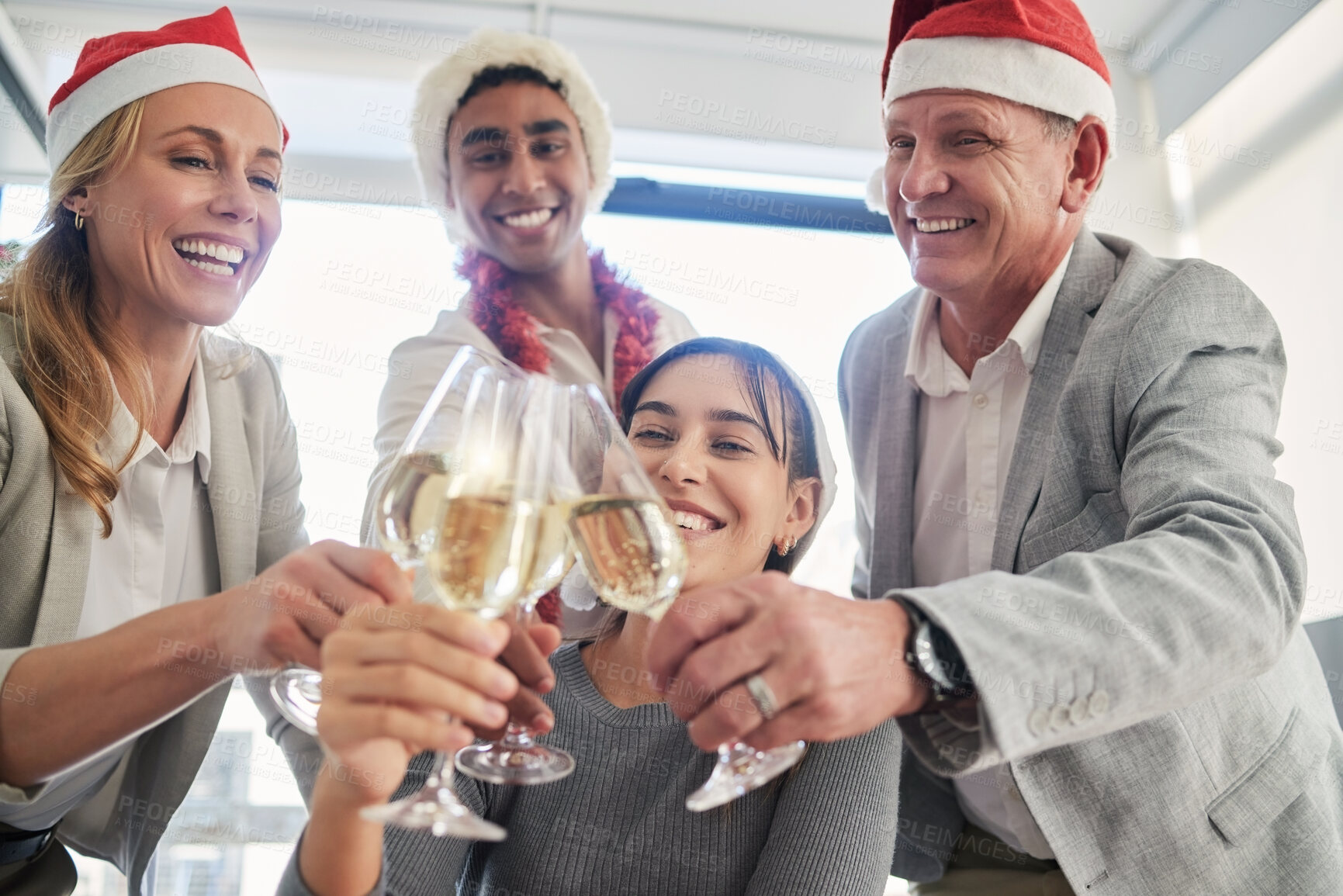 Buy stock photo Shot of a group of business colleagues having a celebratory drink in an office