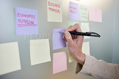 Buy stock photo Shot of an unrecognizable woman using sticky notes on a board