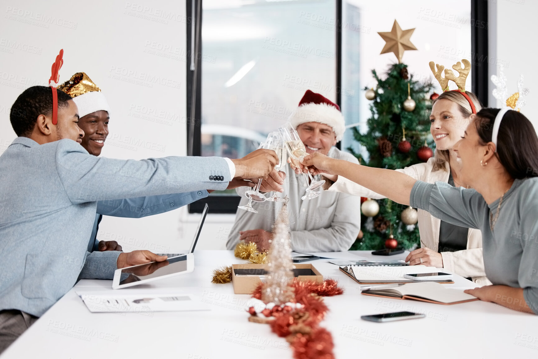 Buy stock photo Shot of a group of businesspeople working together in a boardroom and toasting celebratory drinks