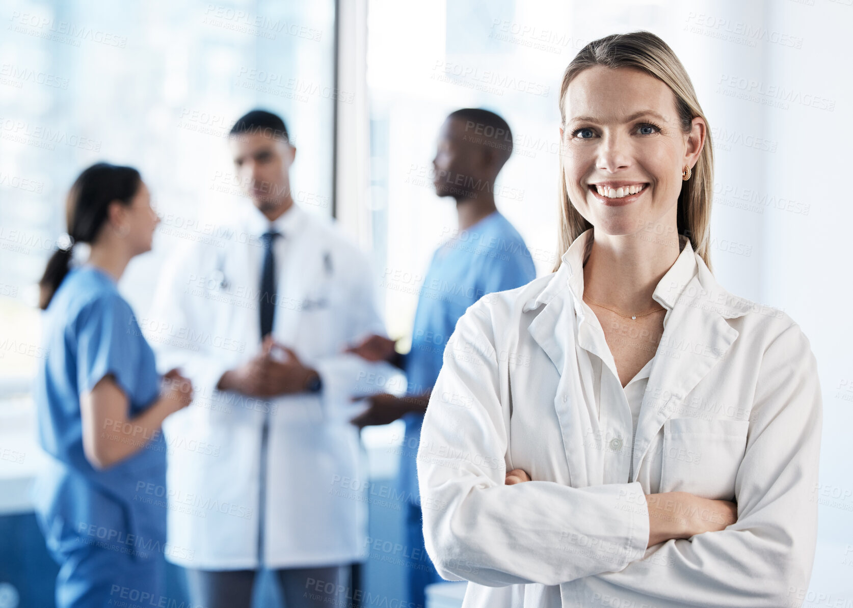 Buy stock photo Doctor, woman and arms crossed with smile in portrait, hallway and pride for medical career in hospital. Person, leadership and happy by team for advice for services, healthcare or wellness at clinic