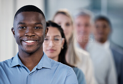 Buy stock photo Portrait of a confident young businessman standing in an office with his colleagues in the background