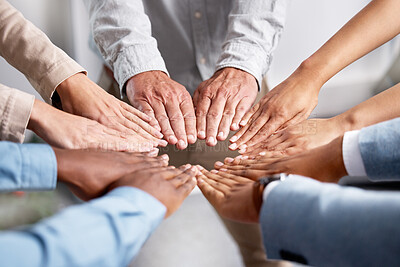 Buy stock photo Shot of a group of businesspeople joining hands in solidarity