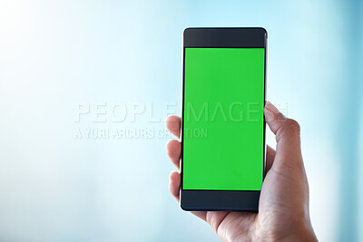 Buy stock photo Shot of an unrecognisable person using a smartphone with a green screen on it