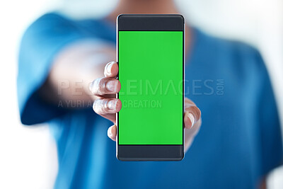 Buy stock photo Shot of an unrecognisable doctor using a smartphone with a green screen on it