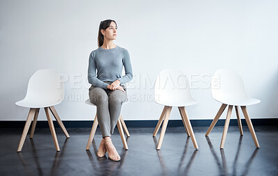 Buy stock photo Shot of a young businesswoman waiting in line at an office