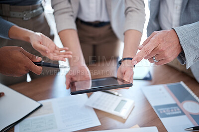 Buy stock photo Cropped shot of a group of unrecognizable businesspeople looking over a tablet in the boardroom