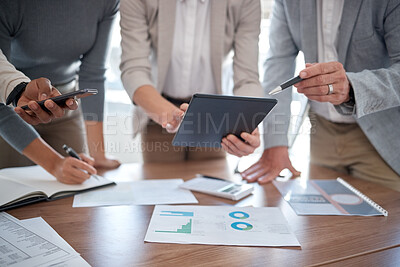 Buy stock photo Cropped shot of a group of unrecognizable businesspeople looking over a tablet in the boardroom