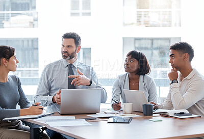 Buy stock photo Cropped shot of a group of businesspeople having a meeting in the boardroom