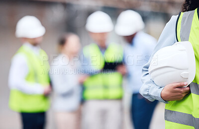 Buy stock photo Shot of an unrecognizable architect holding a helmet at a building site