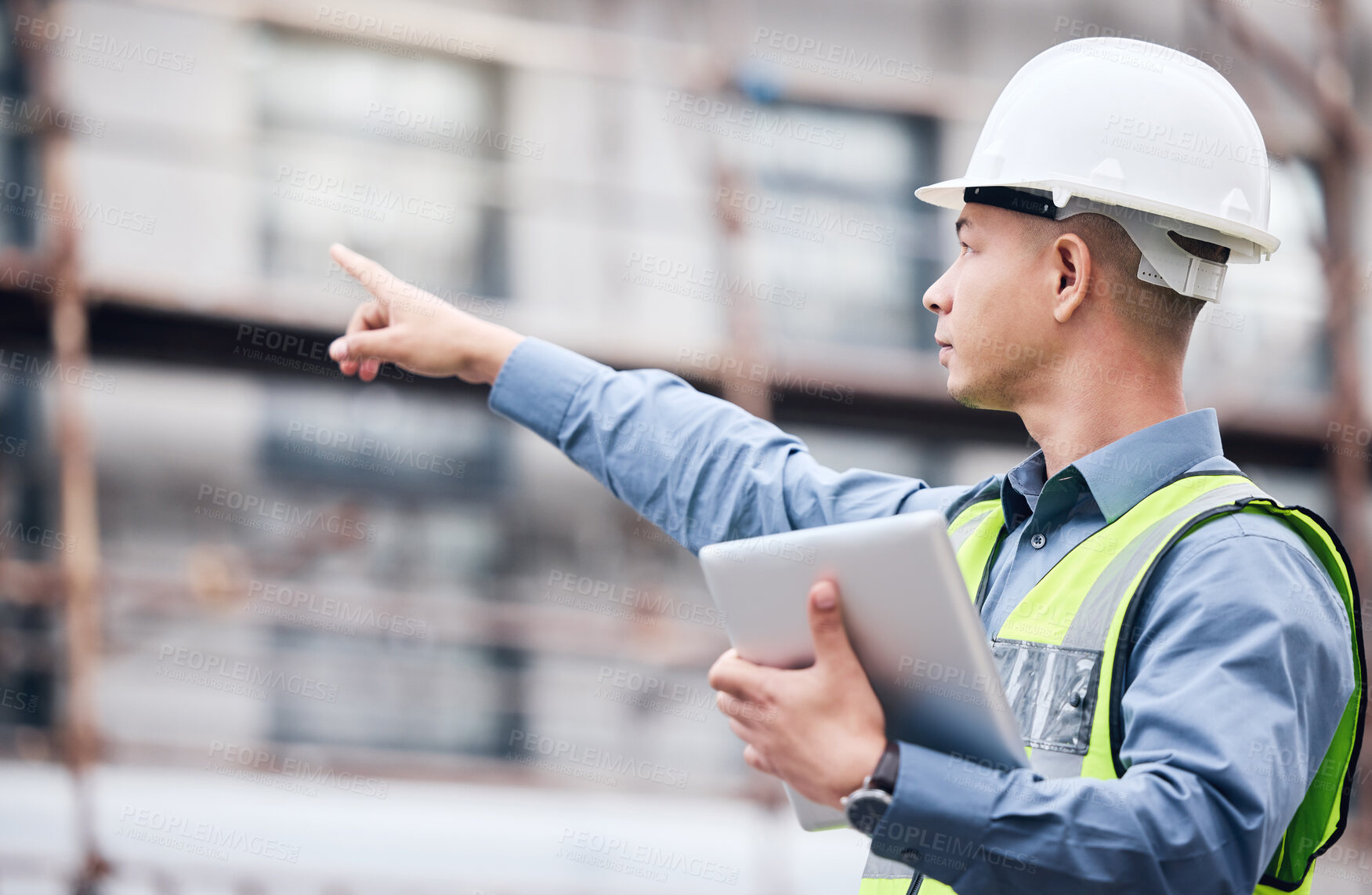 Buy stock photo Shot of a mature male architect using a digital tablet at a building site
