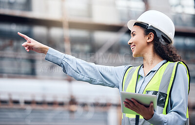 Buy stock photo Shot of a young female architect using a digital tablet at a building site