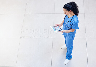 Buy stock photo High angle shot of a young female doctor using a digital tablet at a clinic