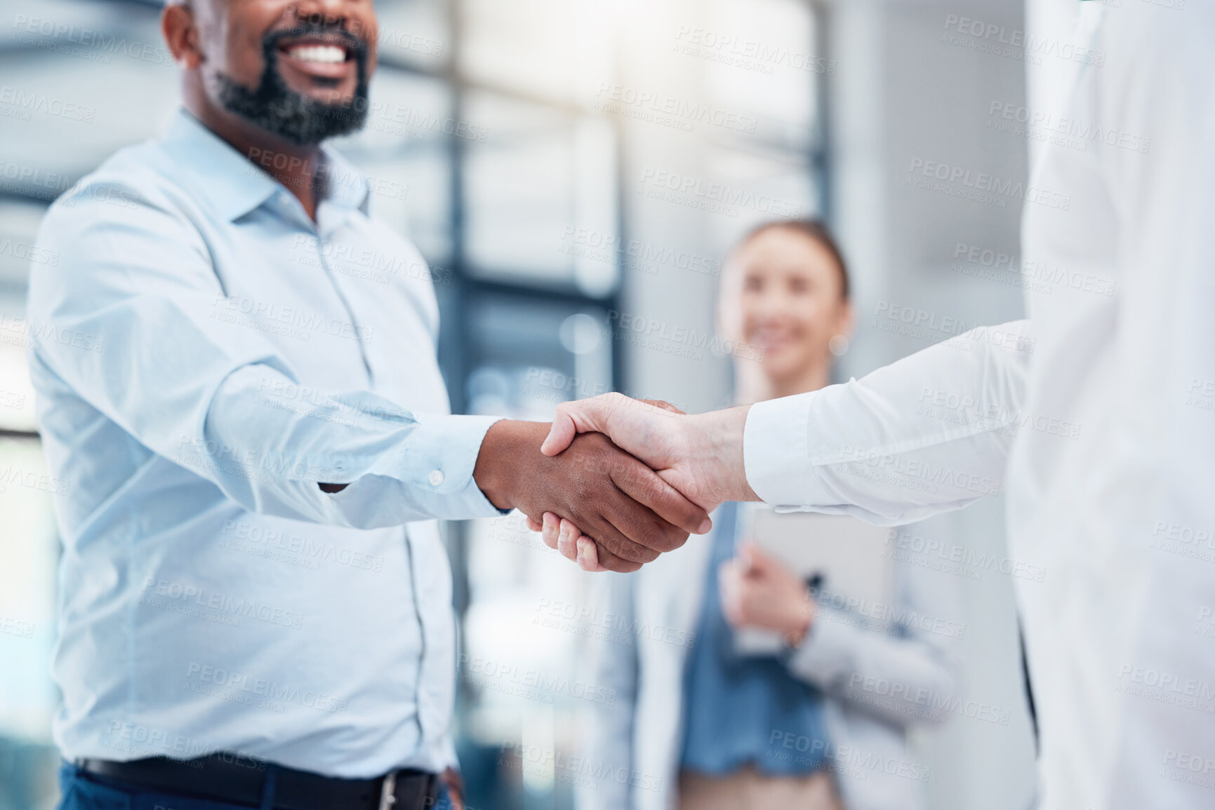 Buy stock photo Shot of two unrecognizable businesspeople shaking hands in an office at work