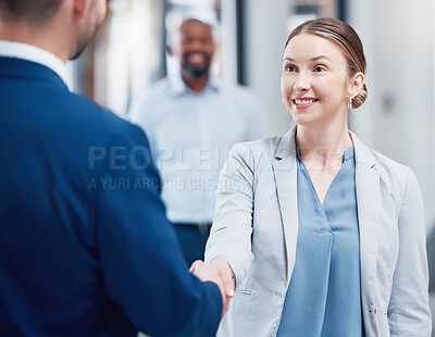 Buy stock photo Shot of two businesspeople shaking hands in an office at work