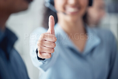 Buy stock photo Closeup shot of an unrecognisable call centre agent showing thumbs up in an office