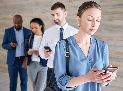 Buy stock photo Shot of a mature businesswoman using a phone while waiting in line at an office