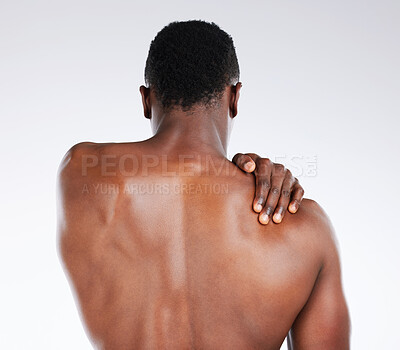 Buy stock photo Black man, back and pain with injury in fitness for muscle tension, sprain or joint inflammation on a white studio background. Young African, male person or model with sore trapezius, bruise or ache