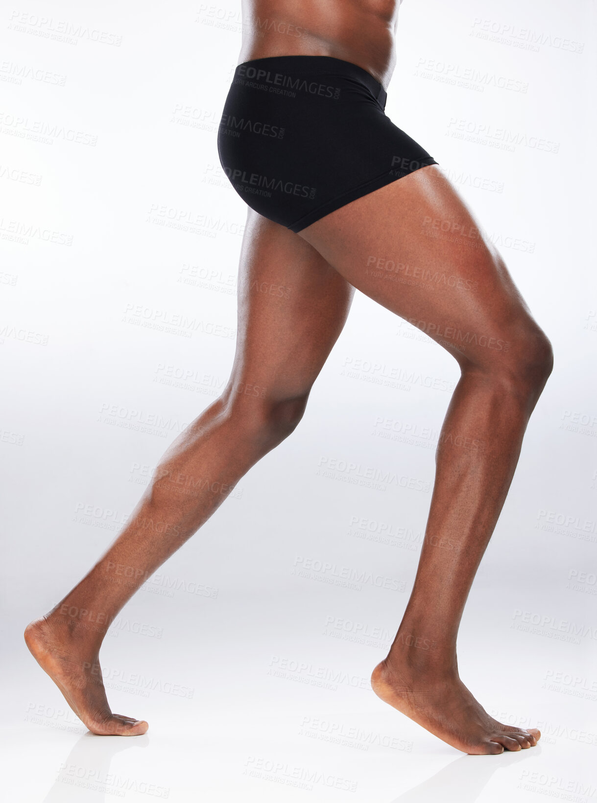 Buy stock photo Legs, black man and underwear in studio for fitness, exercise or wellness and body care for muscles. Feet, male person and athlete or bodybuilder by white background for workout, sport and flexing 