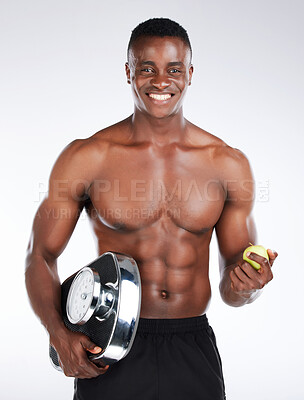 Buy stock photo Studio, portrait and happy man with weight scale for fitness, measure and tracking health with pride. Black person, diet and apple fruit for vitamin c, nutrition and wellness by white background