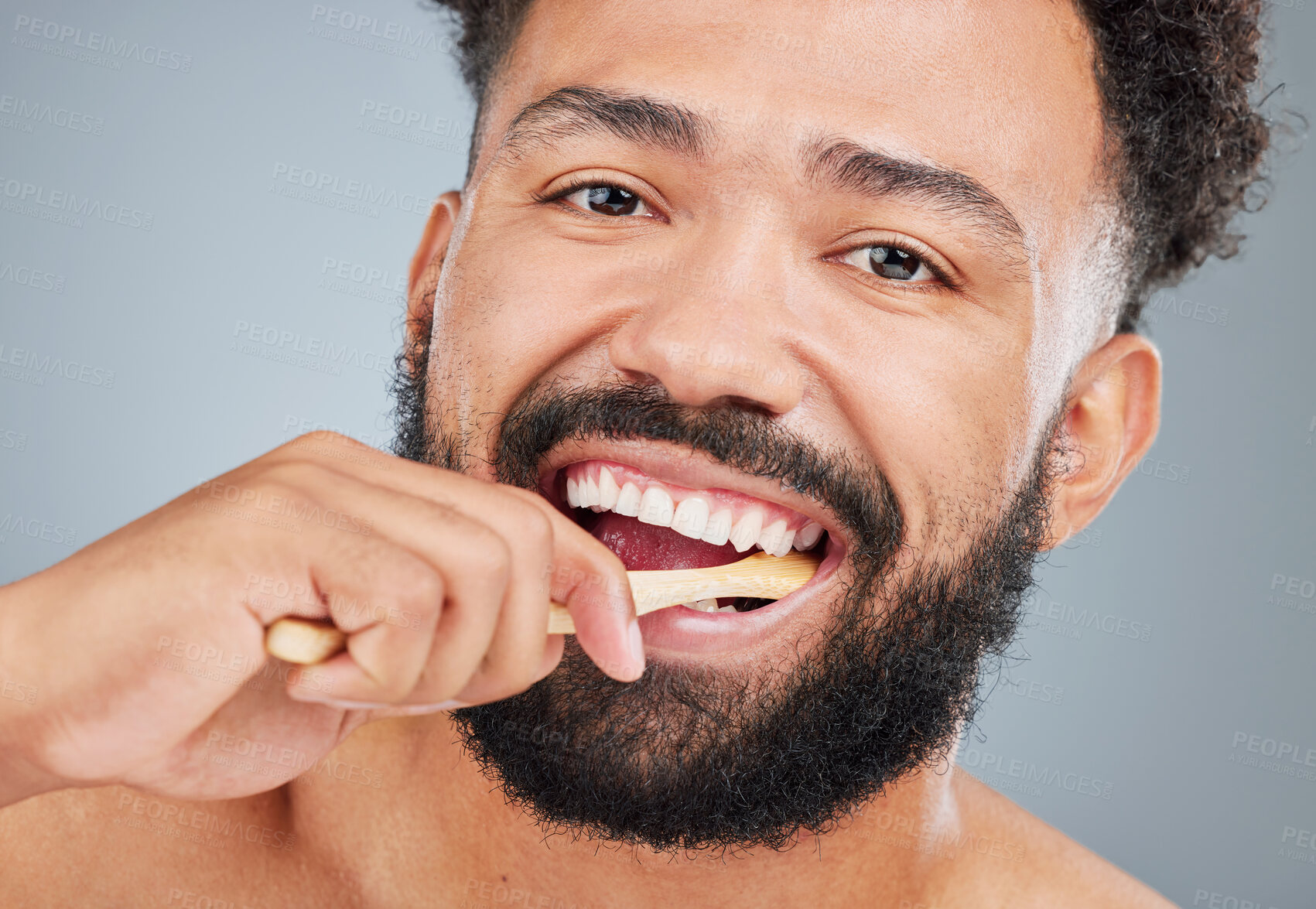 Buy stock photo Man, portrait and brushing teeth in studio for dental care, plaque removal and fresh breath for mouth. Person, gray background and toothbrush for oral hygiene or wellness routine and white smile.