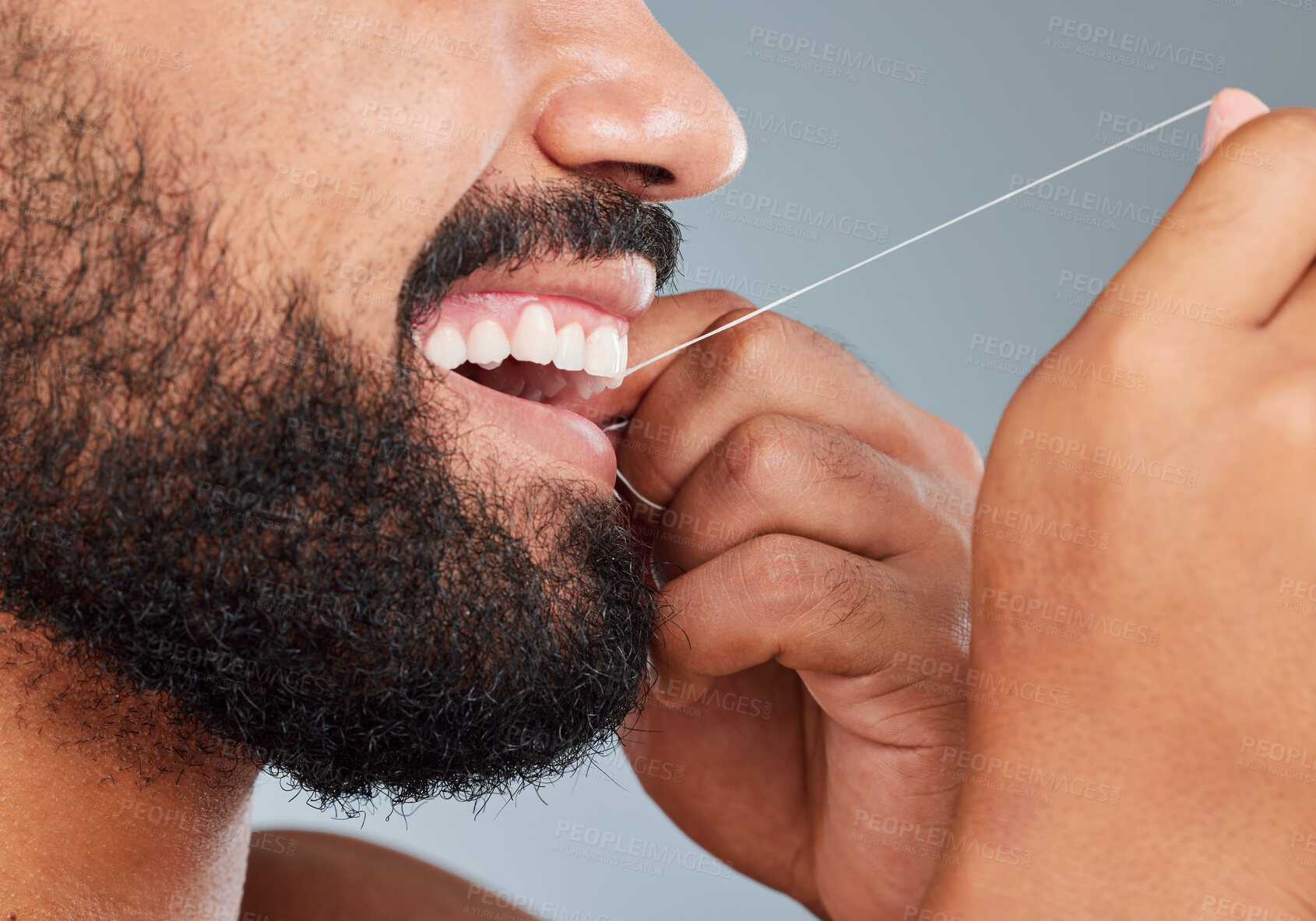 Buy stock photo Oral care, floss and mouth of man in studio for gum, protection and plaque removal. Male person, teeth and thread in hands for cleaning, hygiene and dental wellness on gray background in morning