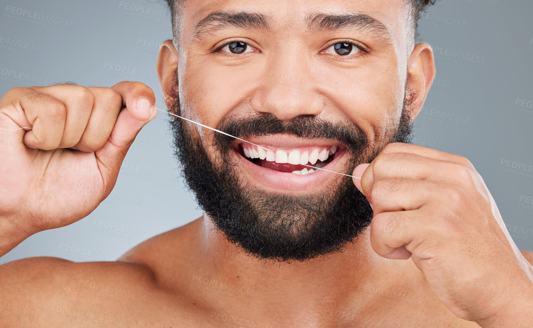 Buy stock photo Dental care, floss or portrait of man in studio for hygiene, plaque removal or clean with thread. Face, male person or oral wellness on gray background for breath, morning routine or gum gingivitis