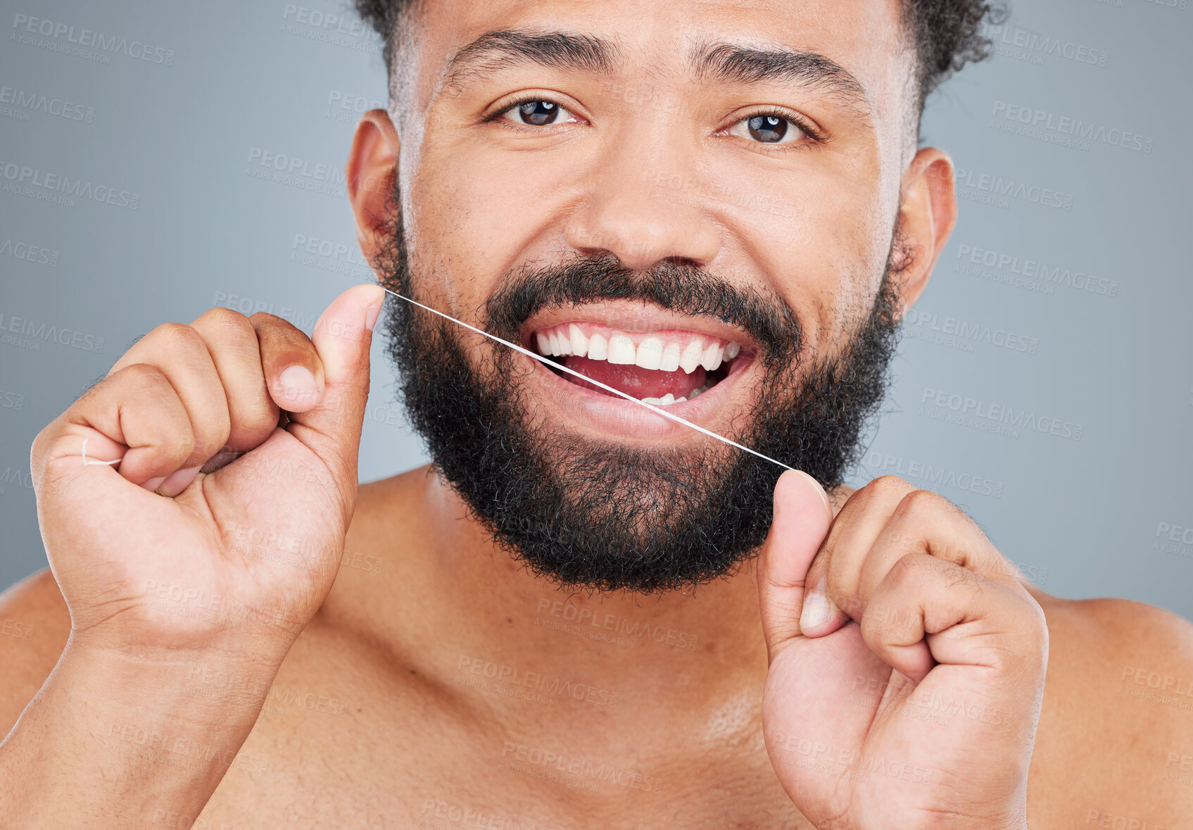 Buy stock photo Oral health, floss or portrait of man in studio for hygiene, plaque removal or clean with thread. Face, male person or dental wellness on gray background for breath, morning routine or gingivitis