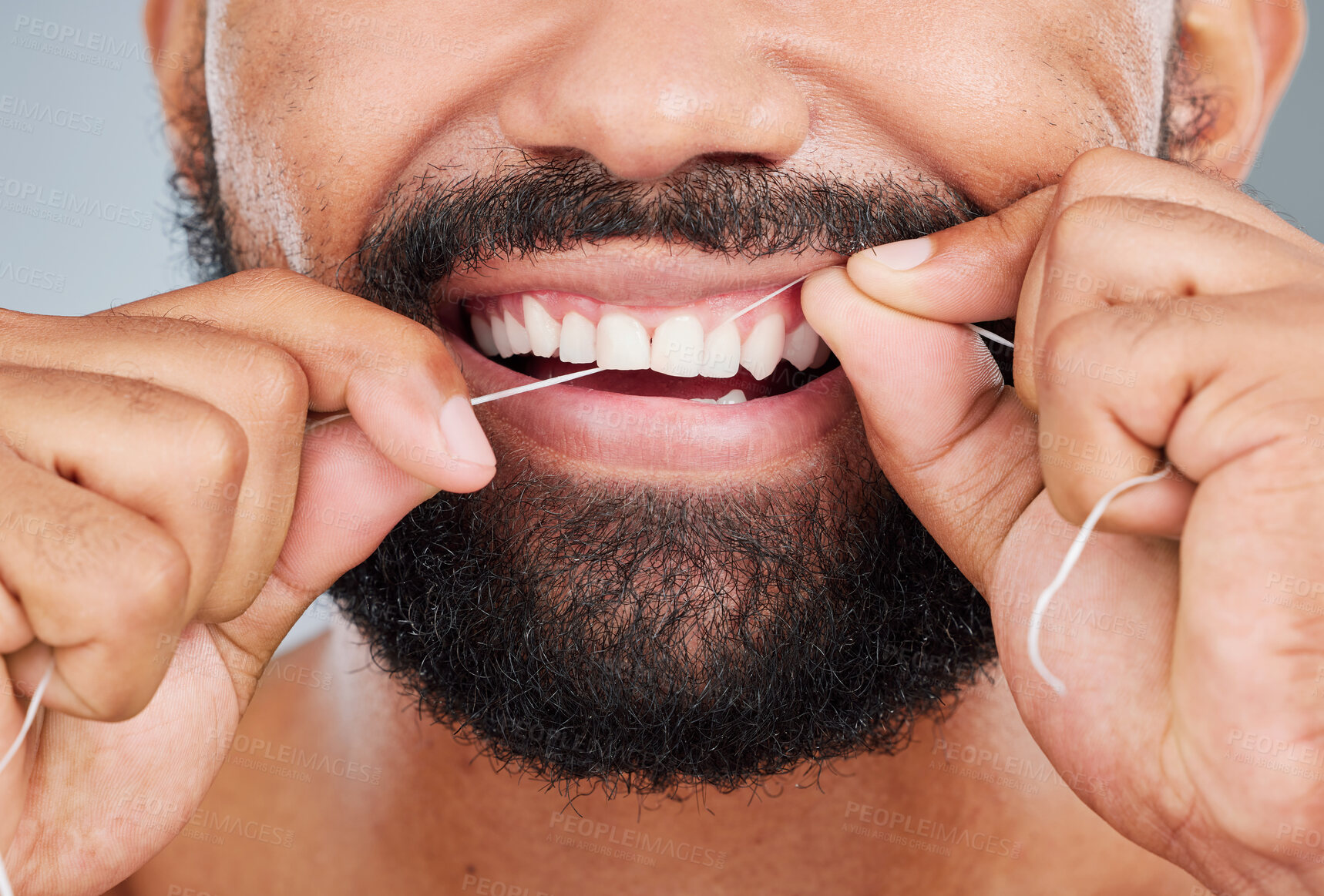 Buy stock photo Dental hygiene, floss and mouth of man in studio for health, plaque removal or clean with thread. Male person, product or oral care on gray background for fresh breath, routine or gum gingivitis