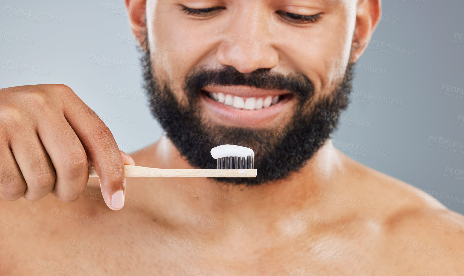 Buy stock photo Man, toothpaste and toothbrush in studio for dental care, plaque removal and fresh breath for mouth. Person, gray background and oral hygiene for wellness routine and white smile or gum health.