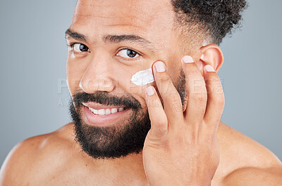 Buy stock photo Happy, cream and portrait of man in studio for skincare, facial treatment and skin tone or hydration. Male person, lotion and sunscreen for uv protection on gray background, closeup and grooming.