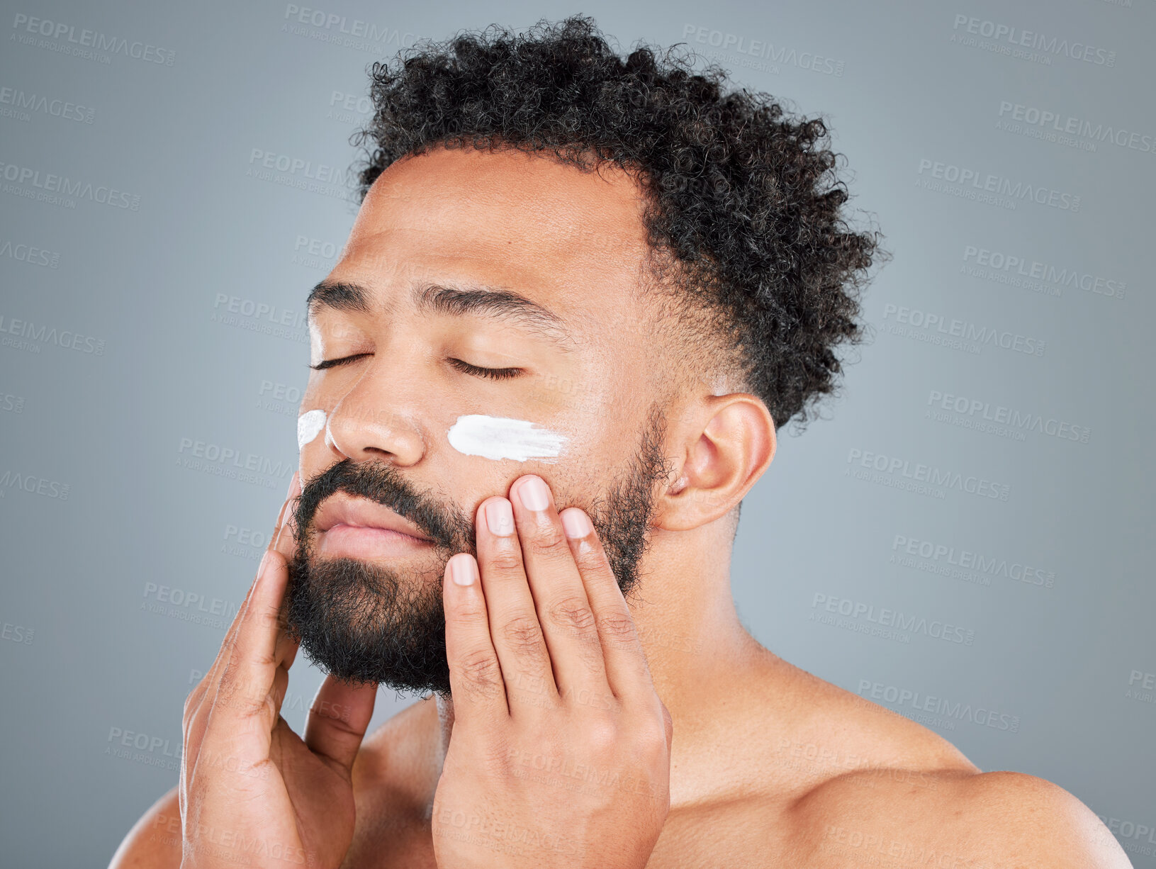 Buy stock photo Calm, cream and man with eyes closed in studio for skincare, facial treatment and skin tone for hydration. Male person, lotion and sunscreen for uv protection on gray background, beauty and grooming