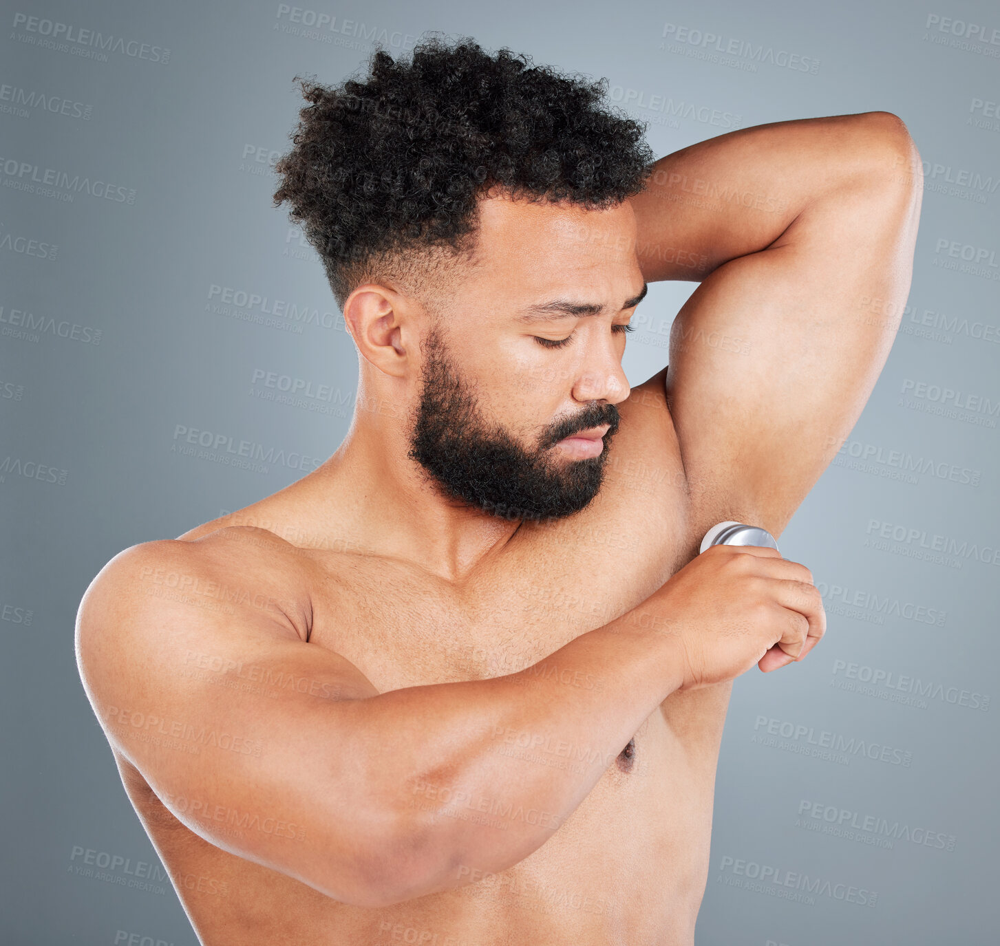 Buy stock photo Man, apply deodorant and skincare in studio, underarm and grooming cosmetics on gray background. Male person, armpit and roll on for hygiene treatment, clean smell and antiperspirant for sweating