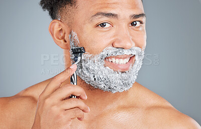 Buy stock photo Man, portrait and shaving cream or blade in studio, foam and grooming routine on gray background. Male person, smile and cosmetics for hair removal, beauty and razor for facial treatment or hygiene