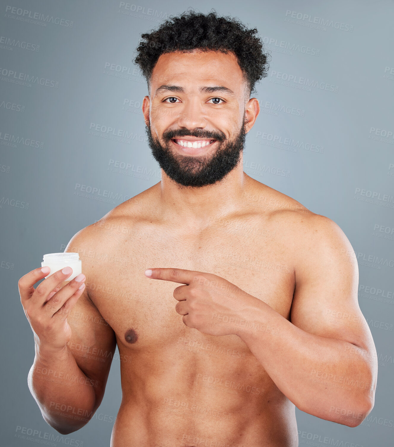 Buy stock photo Portrait, happy man and pointing in studio for cream, dermatology and pride for grooming. Male model, wellness and shine or glow for facial treatment or routine in morning with spf by gray background