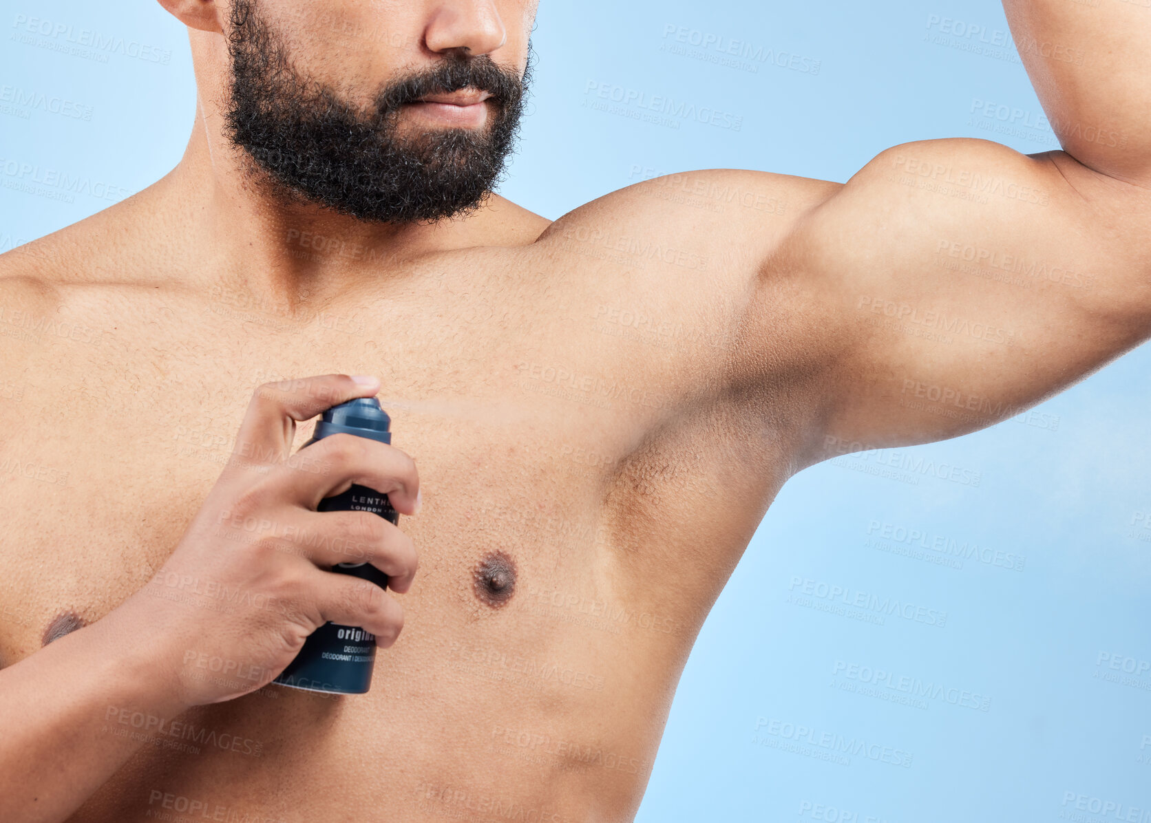 Buy stock photo Man, apply deodorant and spray in studio, underarm and grooming cosmetics on blue background. Male person, armpit and fragrance for hygiene treatment, clean smell and antiperspirant for sweating