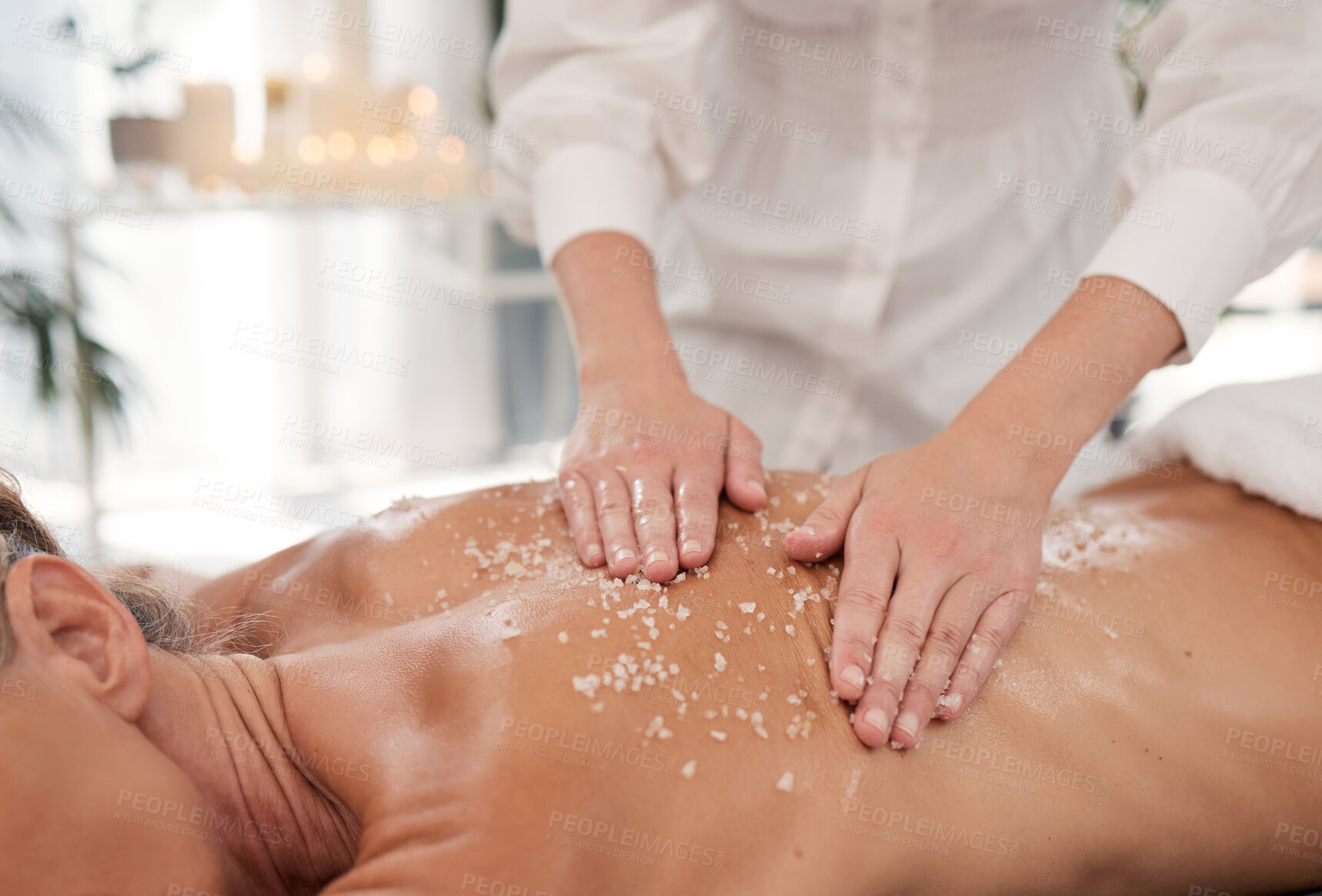 Buy stock photo Spa, hands and person with salt for skincare, exfoliation and wellness for skin massage with relax. Beauty salon, client and masseuse for customer service, hospitality and scrub for retreat therapy