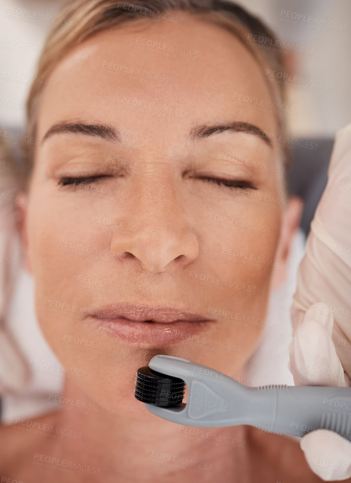 Buy stock photo Spa, facial and woman with derma roller for mesotherapy, skincare and collagen treatment with anti aging benefits. Cosmetics, dermatology and client at beauty salon for microneedling skin process