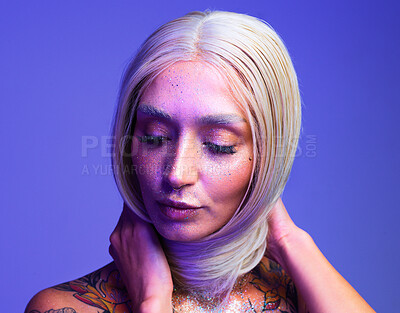 Buy stock photo Studio shot of an attractive young woman posing against a purple background