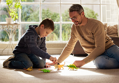 Buy stock photo Shot of a father and son bonding on the lounge floor at home