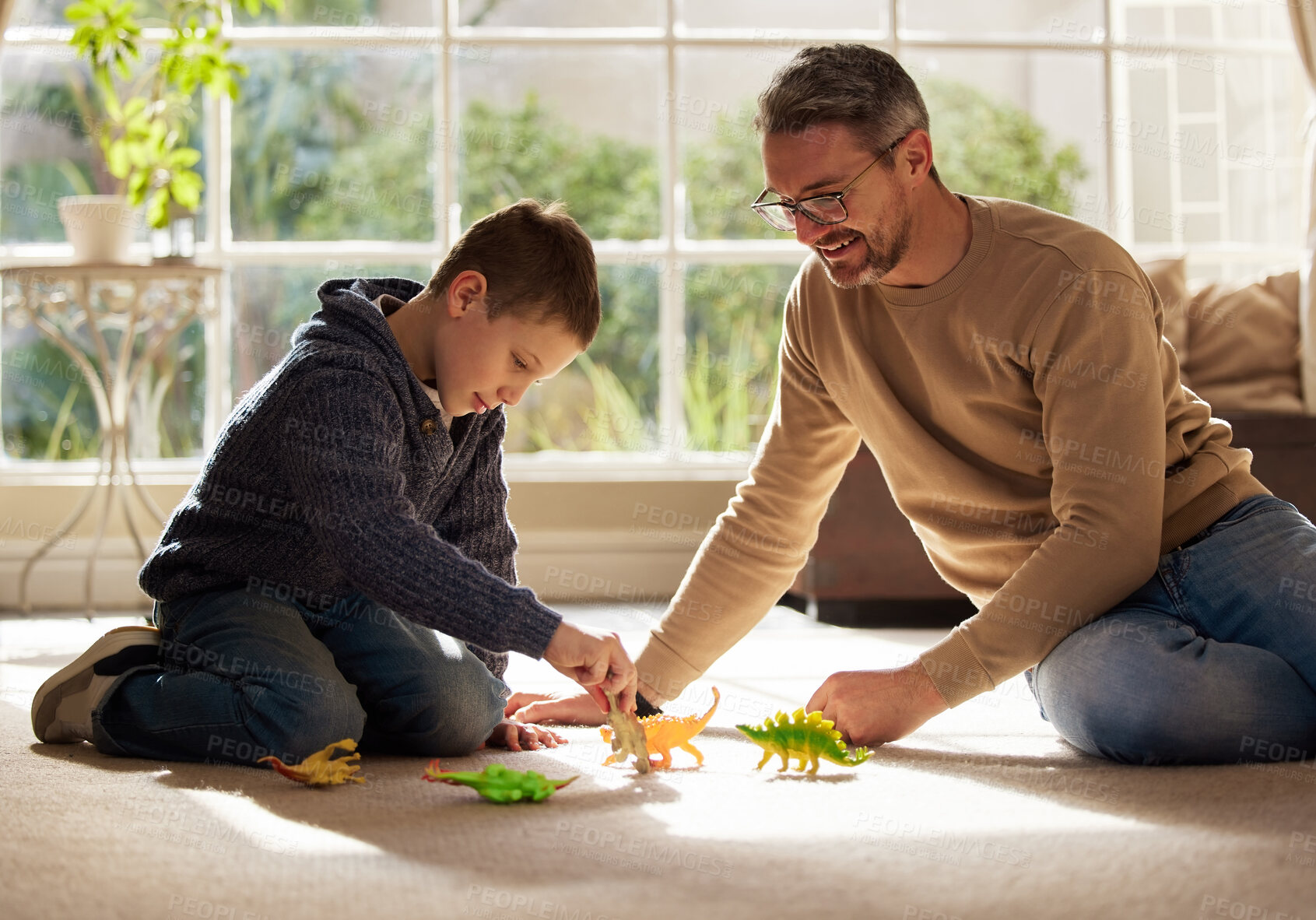 Buy stock photo Father, kid and play with toys at house for plastic dinosaur, learning and fantasy games of animal education. Smile, family and reptiles with creative development, bonding together and childhood fun