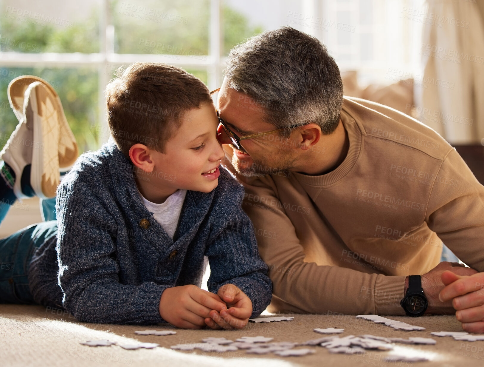 Buy stock photo Father, son and play with puzzle at house for problem solving, learning and connect pieces of education. Smile, family and jigsaw fun with creative development, bonding together and childhood support