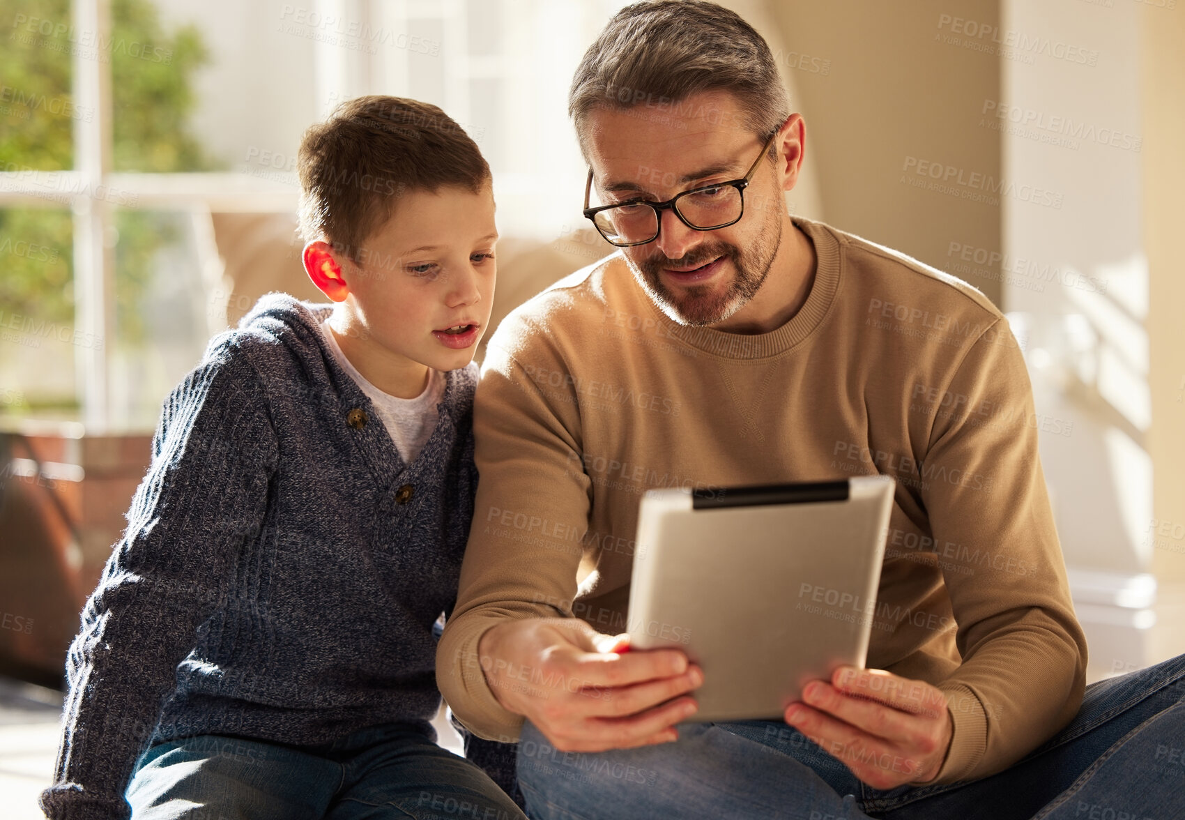 Buy stock photo Home, father and boy with tablet, love and bonding together with happiness, connection and social media. Single parent, dad or son with tech, talk or digital app with internet, website info or relax